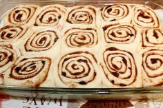 a glass baking dish filled with cinnamon rolls