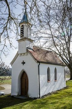 an old white church with a blue steeple