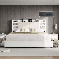 a white bed sitting in a bedroom on top of a hard wood floor next to a book shelf