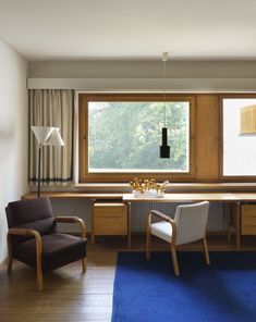 a living room filled with furniture next to a window