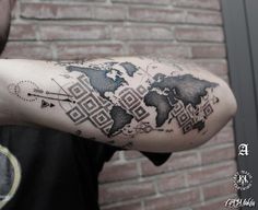 a man with a world map tattoo on his arm