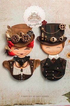 two paper dolls wearing hats and steampunks