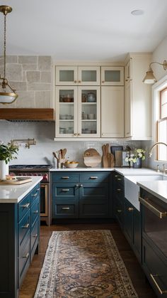 a kitchen with blue cabinets and an area rug in front of the counter top,