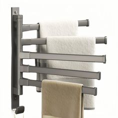 a towel rack with towels hanging from it's sides and two folded towels on the other side