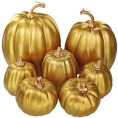 five golden pumpkins sitting next to each other