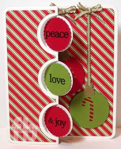 an ornament hanging from a card with the word love and joy on it