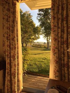 an open door leading to a lush green field