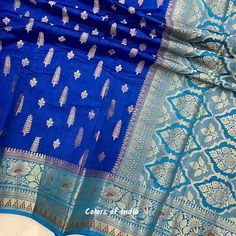 Blue saree blouse  , Georgette saree with zari borders , Semi georgette sarees for women , FREE SHIPPING This is a handwoven semi  georgette saree in  beautiful eye catching  colors . Each saree  comes with zari butis all over the body ,  floral zari borders on both the sides  and a very heavily embroidered  pallu . All the sarees come with  an unstitched blouse piece .  MATERIAL : Semi  Georgette  MEASUREMENTS : Width of the Saree :  44  Inches  Length of the Saree :  5.50 meters  Matching  Blo Blue Bollywood Banarasi Silk Pre-draped Saree, Blue Georgette Pre-draped Saree With Self Design, Blue Katan Silk Pre-draped Saree With Zari Work, Blue Self-design Georgette Lehenga, Blue Pre-draped Saree With Unstitched Blouse For Festivals, Blue Dola Silk Pre-draped Saree With Zari Weaving, Blue Dola Silk Pre-draped Saree With Pallu, Blue Chanderi Pre-draped Saree With Motifs, Blue Pre-draped Saree With Zari Weaving