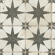 an artistic tile design with black and white stars