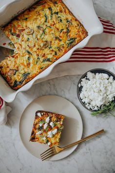 a casserole dish with spinach and feta cheese next to it on a plate