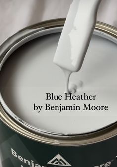 a can of white paint with the words blue heather by benjamin moore