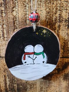 a wooden ornament with a snowman on it