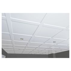 an empty room with white ceiling tiles on the ceiling and light fixtures in the ceiling