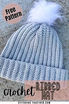 a crochet ribbed hat with a white pom - pom on top