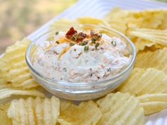 a bowl filled with dip surrounded by chips