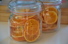 three glass jars filled with sliced oranges