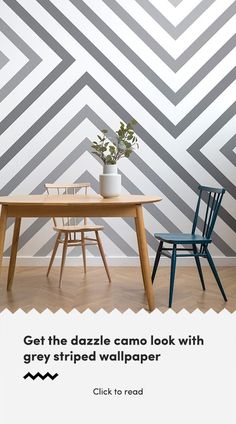 a table with two chairs and a plant on it in front of a geometric wallpaper