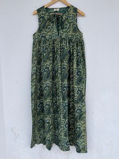 "Long maxi dress, ajrakh printed dress, ajrakh block printed maxi, cotton dress, hippie dress, bohemian maxi, cotton maxi, paisley printed dress, comfortable dresses, ajrakh printed hippie dress, summer dress, Indian seller, customised dress available, Indian wholesaler, comfy dress, sleeveless dress Feel beautiful and confident throughout your days wearing our Ajrakh block printed outfits, made with high quality soft and breathable cotton fabric.  The print on the dress is known as \"AJRAKH PRINT\" which is centuries old technique of Indian textile carried out  by local artisans of Jaipur (INDIA) MEASUREMENTS (in inches): Size XXS-: Bust- 34″ | Shoulder- 13.5″ | Length- 51″ Size XS-: Bust- 36″ | Shoulder- 14″ | Length- 51″ Size S-: Bust- 38″ | Shoulder- 14.5″ | Length- 51″ Size M-: Bust- Green Maxi Dress With Printed Motifs, Sleeveless Cotton Maxi Dress With Boho Print, Sleeveless Cotton Boho Print Maxi Dress, Bohemian Cotton Maxi Dress With Batik Print, Green Bohemian Dress With Kalamkari Print, Bohemian Bandhani Print Maxi Kurta, Bohemian Bandhani Print Maxi Dress, Bohemian Maxi Dress With Bandhani Print, Bohemian Sleeveless Maxi Dress With Paisley Print