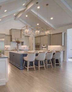 a large open concept kitchen and dining room with an island in front of the sink