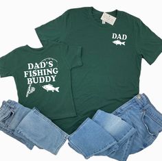 DAD'S FISHING BUDDY Shirt and DAD Shirt - the perfect matching shirt set! These shirts are super soft and make a great gift for any Dad who loves fishing! To purchase each shirt, simply choose your Design, then Size, then Add to Cart. Repeat this step for each shirt you would like to purchase. Professionally screen printed. Shirt color is Forest Green. Print color is White. ADULT TEE Super soft, made of 100% ringspun cotton. Standard adult unisex sizing. Retail fit. We recommend ordering the same size you normally wear in an adult unisex tee. For men, some prefer to size up for a more relaxed fit. Refer to Product Images for shirt measurements. KIDS TEE Standard childrens unisex sizing. Made of 100% ringspun cotton. Retail fit. Size Chart is listed below. Kids Tee Size Chart 2T (30-33 lbs) Father's Day Green Short Sleeve Shirt, Green Short Sleeve Shirt For Father's Day, Green Cotton Shirt For Father's Day, Screen Printed Shirt, Dad And Son, Dad Son, Matching Tees, Green Print, Fishing Shirts