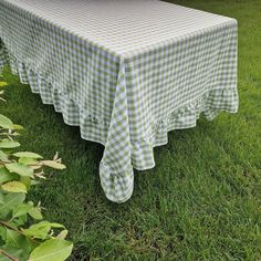 a green and white checkered tablecloth sitting on the grass