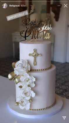 a three tiered cake with flowers and a cross on the top that says god is ultra