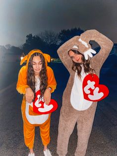 two women dressed in costumes standing next to each other