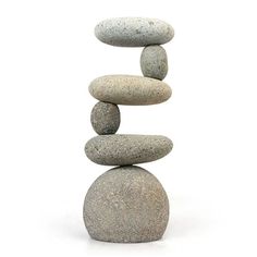 a stack of rocks sitting on top of each other in front of a white background