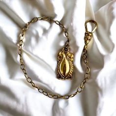 "Antique gold filled pocket watch chain with engraved vest / button hole clip. Lanyard closure with additional mount to add a watch for or other item. Edwardian, early 1900's. Marked \"LB Co\", a gold and silversmith company active from 1859-1935. Antique condition with wear to the patina, particularly on the centre of the clip, as shown in photos. 6\" inches long.  A beautiful grooms or Father's Day gift for that special someone. Contact me for combined shipping or a Canada Post rate." Victorian Gold Engraved Pocket Watch, Vintage Metal Pocket Watch With Chain, Classic Gold Pocket Watch With Locket, Gold Engraved Steampunk Pocket Watch, Timeless Gold Metal Pocket Watch, Vintage Metal Pocket Watch Engraved, Vintage Metal Engraved Pocket Watch, Vintage Engraved Metal Pocket Watch, Heirloom Gold Medallion Pocket Watch