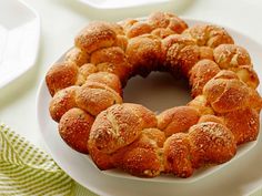 a bundt cake on a white plate sitting on a green and white table cloth