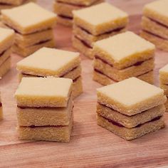 several pieces of cake sitting on top of a wooden cutting board next to each other