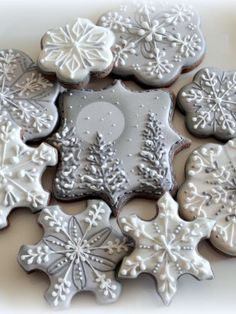 decorated cookies are arranged in the shape of snowflakes