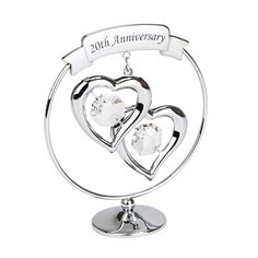 two hearts on a stand with the words 20th anniversary hanging from it's center