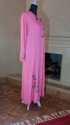 A truly magnificent pink floral caftan made in stunning Mlifa pink fabric is both sophisticated and glamorous. It has unusual bell sleeves, all finished with insanely detailed handmade colorful woven edging. Perhaps for a wedding or very special occasion, this is the perfect complement to your outfit. It’s an instantly amazing way to change your outfit into an incredible one… and is practically effortless. The beautiful ribbon design is set off by gold and pink which sparkles as you move through Pink Kaftan, Moroccan Kaftan, Moroccan Caftan, Gold And Pink, Ribbon Design, Dress Cotton, Kaftan Dress, Kimono Jacket, Pink Fabric