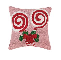 a pink pillow with candy canes on it