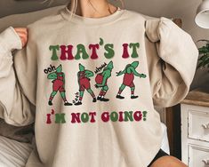 That's It I'm Not Going Sweatshirt, Ooh Aah Grench Christmas T-shirt, Funny Grinchmas Crewneck Shirts, Christmas Gift for Christmas Squad - Soft unisex sweatshirt - High quality design printing -50% cotton, 50% polyester -No itchy side seams! -Sewn in label -Loose Fit -Runs True to size Please note: any styles you see in the main photo such as sleeves rolled up or a knot tied, are just style suggestions and not how the shirt comes. The shirts are a unisex shirt as shown in the color chart.  Note Xmas Tees, Christmas Crewneck, Mugs Stickers, Just Style, Gift Cute, Funny Sweatshirts, Crew Neck Shirt, Cut Shirts, Christmas Tshirts