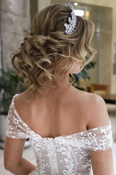 the back of a woman's head wearing a wedding dress