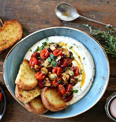 a bowl filled with bread and vegetables on top of a table