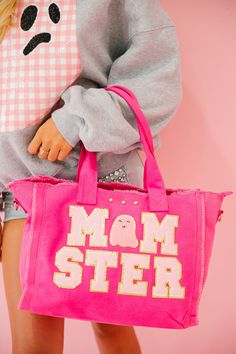 Get ready to be the life of the trick or treating party with our Momster Pink Tote Bag! Carry all the candy you could ever want and show off your playful side with our pink ghost patch! All orders are currently shipping within 14 business days. To receive item quicker, expedited shipping is available at checkout. **ALL HALLOWEEN ORDERS MUST BE PLACED WITH EXPEDITED SHIPPING TO GUARANTEE DELIVERY BY OCT. 31 IF PLACED AFTER OCT. 15** Playful Pink Large Capacity Bags, Playful Large Capacity Pink Bags, Playful Pink Shopping Bag, Playful Pink Shopping Bags, Fun Pink Cotton Bag, Playful Pink Bags For Everyday Use, Playful Pink Bag For Everyday Use, Playful Pink Cotton Bag, Pink Cotton Bag With Double Handle