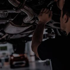 a man working on the underside of a car