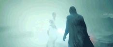 a blurry image of two people standing in the fog