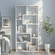 a living room filled with furniture and a white book shelf