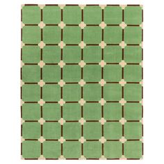 a green rug with brown and white squares on the bottom, in front of a white background