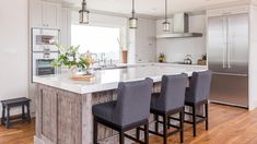 a kitchen with an island and four chairs