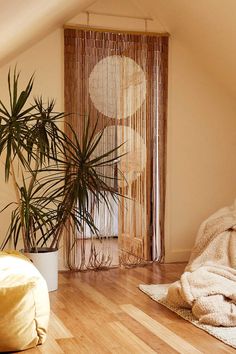 a bedroom with wooden floors and a plant in the corner