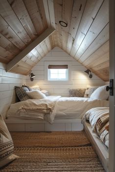 a bed sitting under a window in a bedroom next to a wooden floor and ceiling