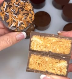 two pieces of food being held in front of each other with chocolate and orange peels