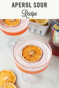 two glasses filled with orange juice and garnished with an orange slice on the rim