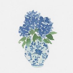 a blue and white vase with flowers in it