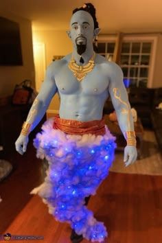 a man dressed in blue and white is standing on a wooden floor